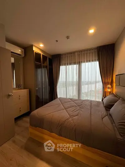 Cozy bedroom with large window offering stunning river view, featuring modern furniture and ambient lighting.