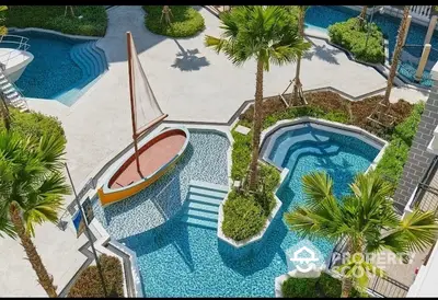 Luxurious pool area with sailboat feature and lush landscaping