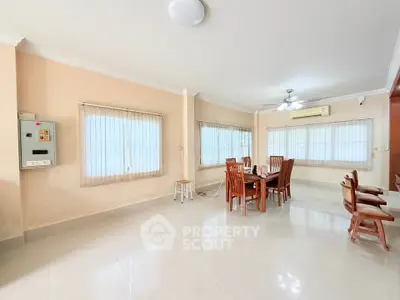 Spacious dining area with elegant wooden furniture and ample natural light.