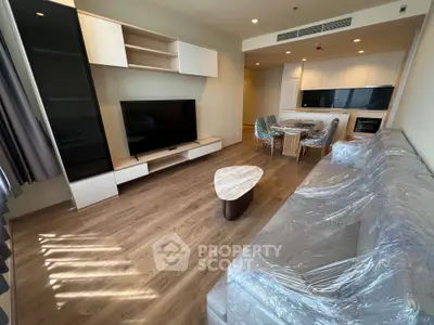 Modern living room with sleek furniture and open kitchen layout