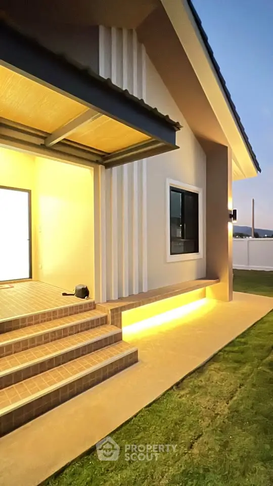 Modern house exterior with illuminated entrance and stylish design