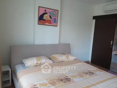 Cozy bedroom with modern decor and air conditioning, perfect for relaxation.