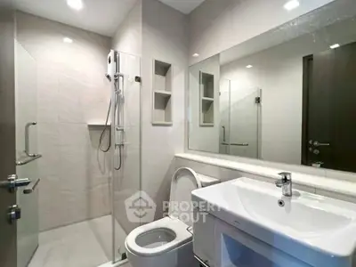 Modern bathroom with sleek fixtures and glass shower enclosure