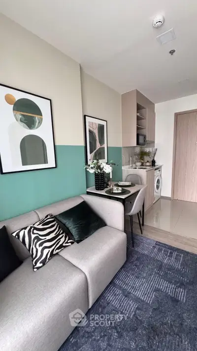 Modern living room with stylish decor and compact kitchen area