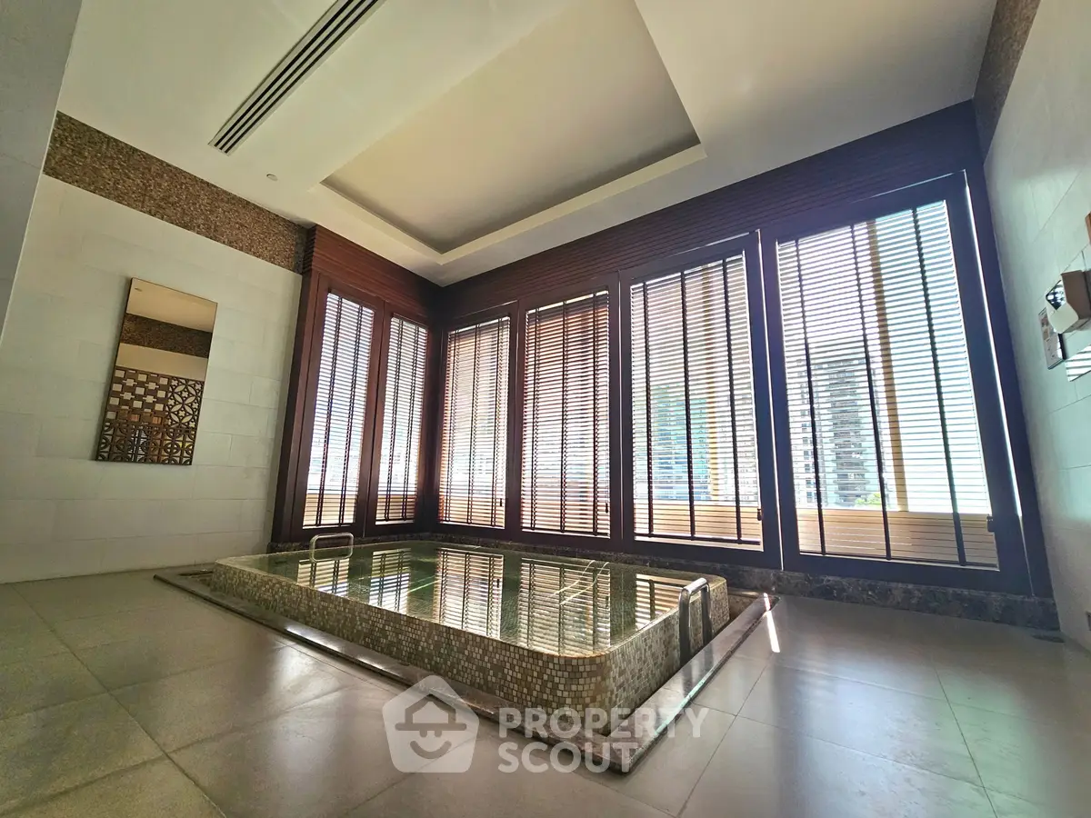 Luxurious indoor pool with floor-to-ceiling windows and elegant design