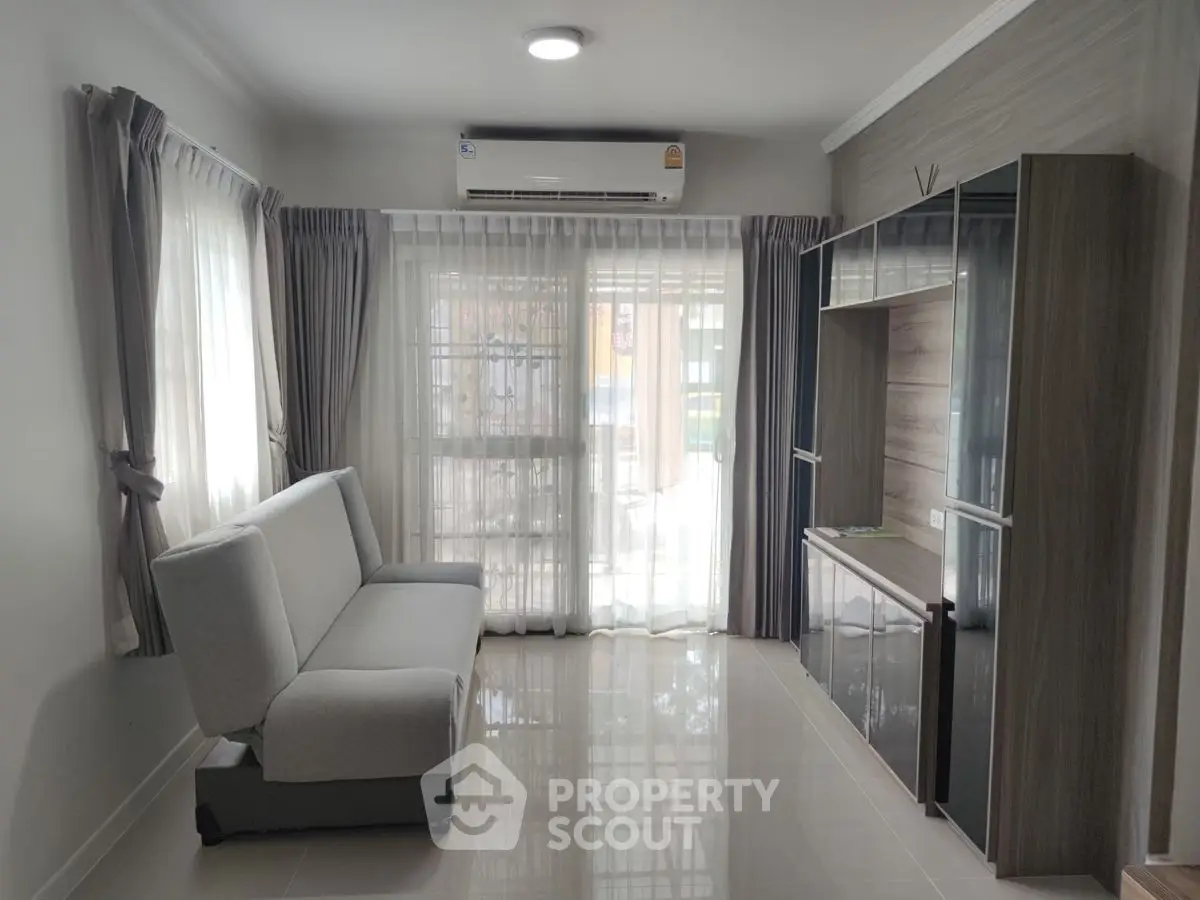 Modern living room with sleek furniture and natural light, perfect for urban living.