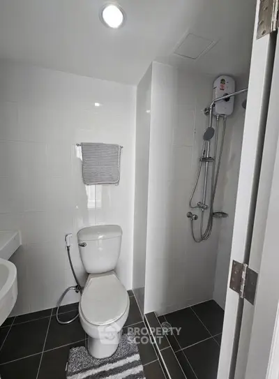 Modern bathroom with sleek fixtures and a shower in a contemporary real estate property.