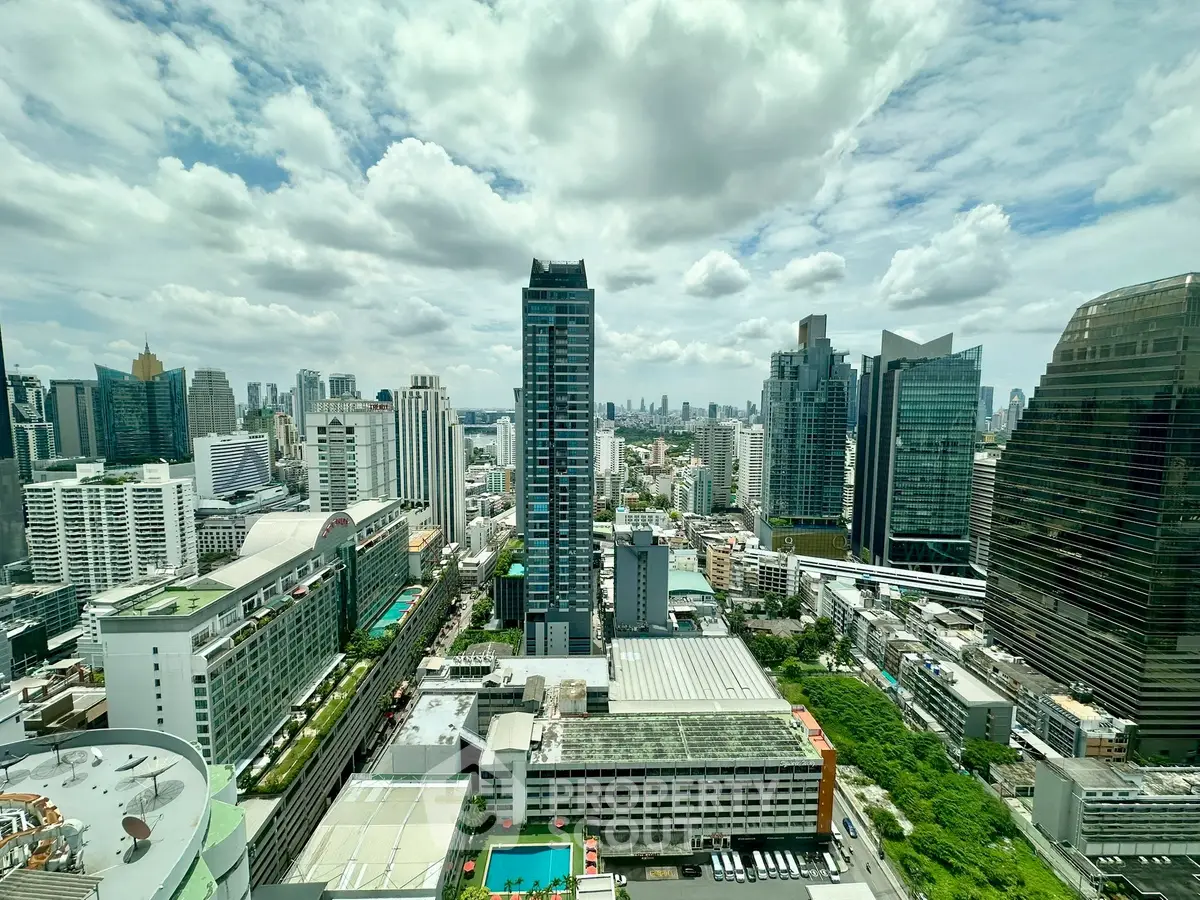 Stunning cityscape view with modern skyscrapers and lush greenery, perfect for urban living enthusiasts.