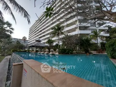 Luxurious condominium with stunning pool and lush garden view