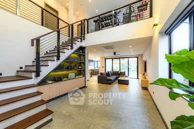 Spacious modern living room with open layout and stylish staircase