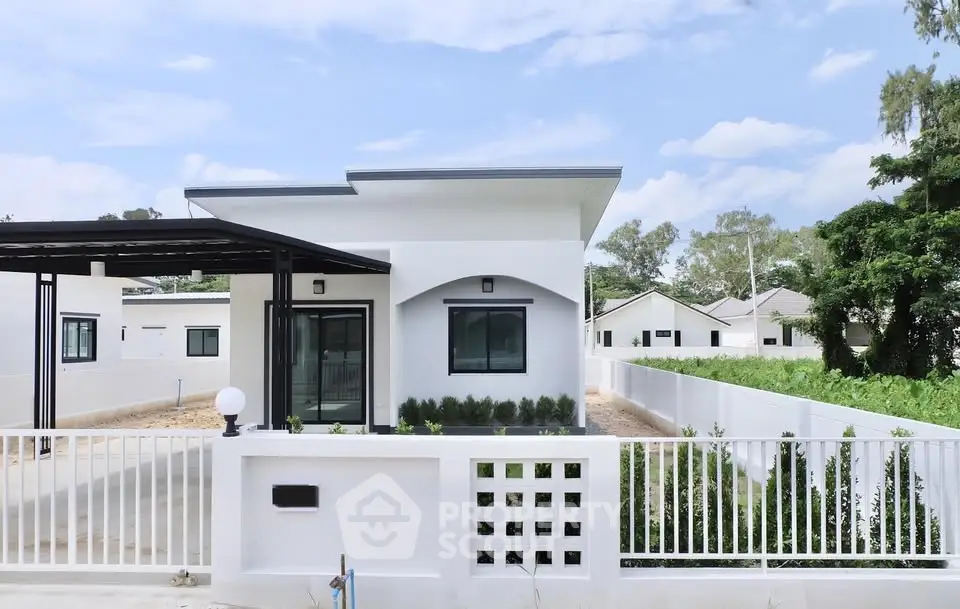 Modern single-story house with sleek design and spacious yard