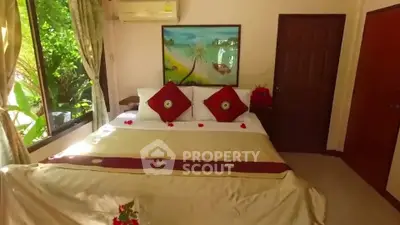 Cozy bedroom with elegant decor and garden view, perfect for relaxation.