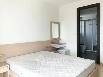 Modern bedroom with ensuite bathroom in a minimalist apartment