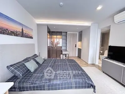 Modern bedroom with stylish decor and open layout in a contemporary apartment.