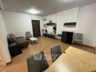 Spacious modern living room with sleek furniture and wooden flooring