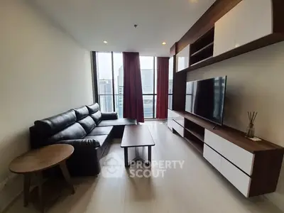 Modern living room with sleek furniture and city view, perfect for urban living.