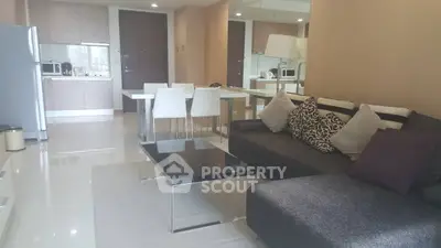 Modern open-layout living room with sleek kitchen and stylish furniture in a contemporary apartment.