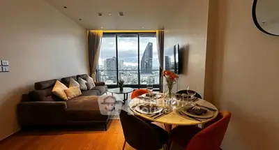 Modern living room with city view, stylish furniture, and dining area in a high-rise apartment.