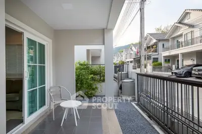 Charming townhouse patio with modern outdoor seating and scenic neighborhood view.