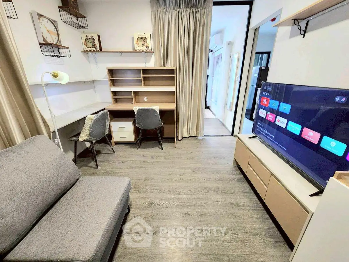 Modern living room with sleek furniture and smart TV, perfect for urban living.