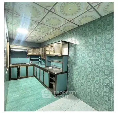 Spacious kitchen with unique tile design and ample cabinetry, perfect for culinary enthusiasts.