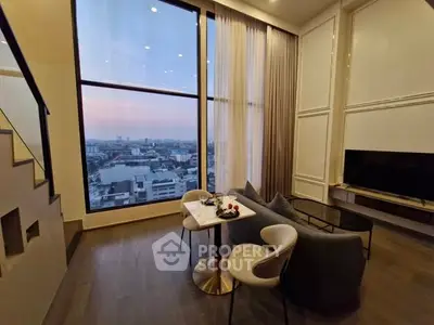 Luxurious living room with stunning city view through large windows, elegant decor and cozy seating.