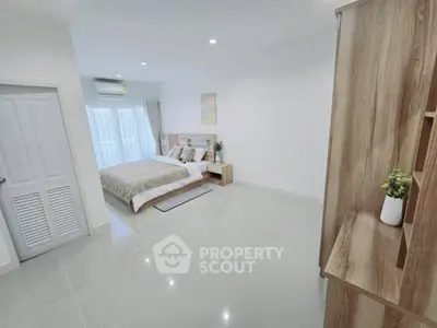 Spacious modern bedroom with elegant decor and natural light