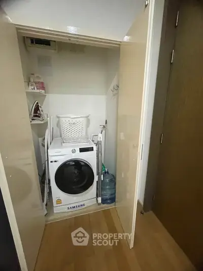 Compact laundry area with Samsung washing machine in modern apartment