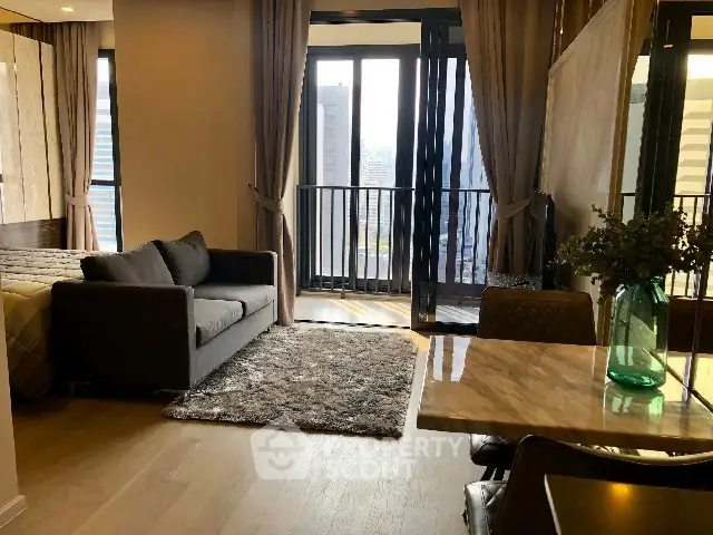 Modern studio apartment with city view, featuring cozy living area and stylish decor.