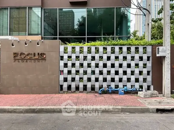 Modern building facade with unique checkered wall design in urban setting