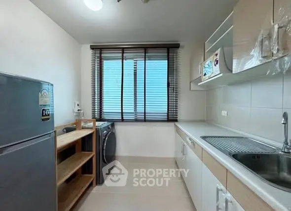 Modern kitchen with sleek appliances and ample natural light
