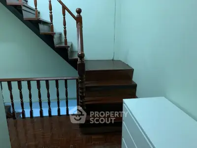 Charming wooden staircase with elegant railing in cozy home interior