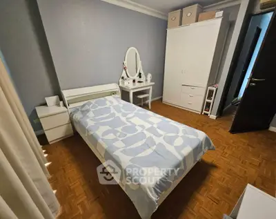 Cozy bedroom with stylish decor and ample storage space