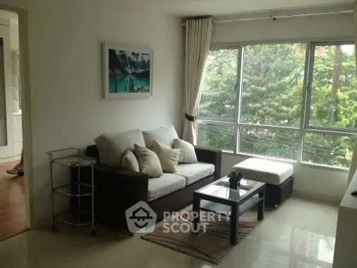 Bright living room with large windows and cozy seating area