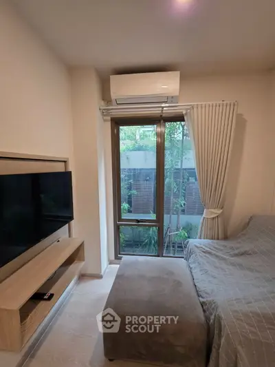 Cozy living room with large window and modern air conditioning unit
