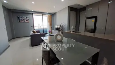Modern open-plan living room with sleek kitchen and city view, perfect for urban living.