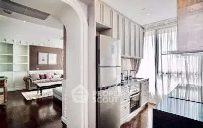 Luxurious open-layout kitchen and living room with elegant decor and natural light
