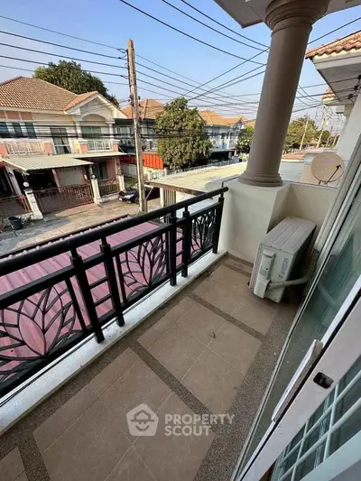 Charming balcony with decorative railing and street view, perfect for relaxation.