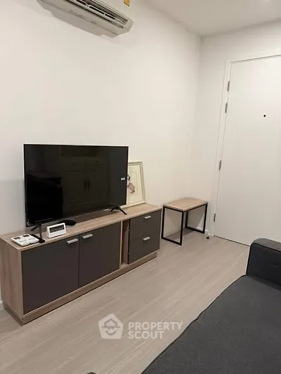 Modern living room with sleek TV stand and air conditioning unit