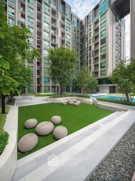 Modern apartment building with landscaped garden and unique seating area