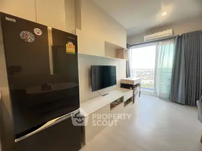 Modern living room with sleek design, featuring a large fridge, wall-mounted TV, and balcony access.