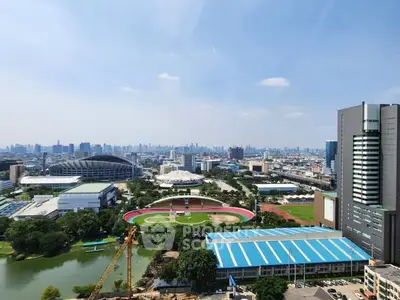 Stunning cityscape view with modern buildings and sports complex, perfect for urban living enthusiasts.