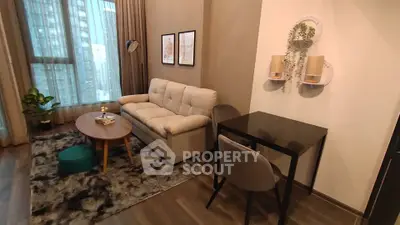 Modern living room with cozy sofa, stylish decor, and city view window in urban apartment.