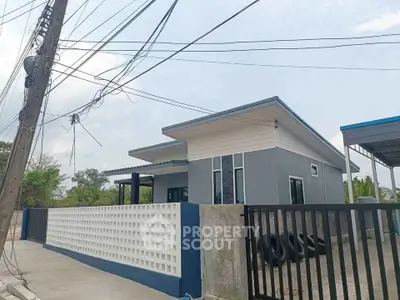Modern single-story house with sleek design and spacious outdoor area.