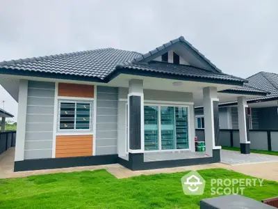 Modern single-story house with stylish roof and lush green lawn