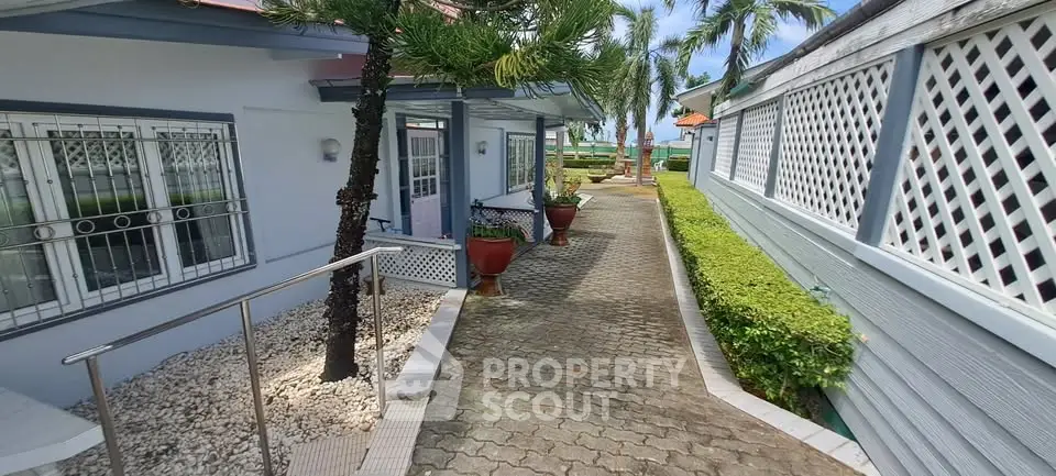 Charming coastal property with lush greenery and inviting walkway