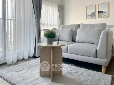 Modern living room with stylish gray sofa and natural light