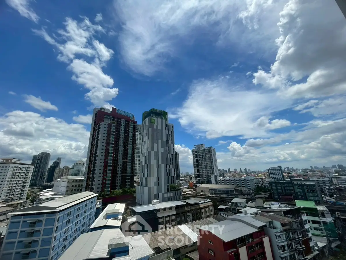 Stunning cityscape view with modern high-rise buildings under a vibrant blue sky.