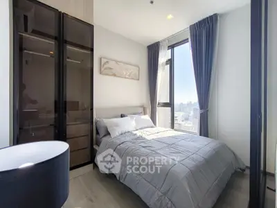 Modern bedroom with city view, featuring sleek design and ample natural light.