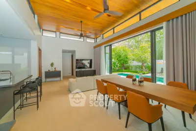 Spacious modern living room with pool view and elegant dining area